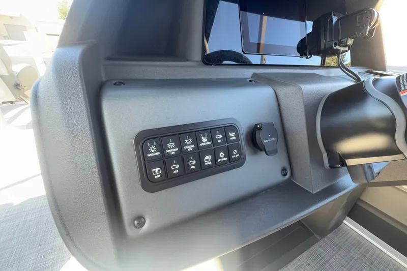 Slide: The Image of Control panel of 2027 Sun Tracker SportFish 20 DLX boat with various switches. - 21