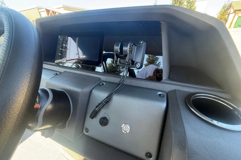 Slide: The Image of Dashboard of 2027 Sun Tracker SportFish 20 DLX boat with steering wheel and controls. - 22