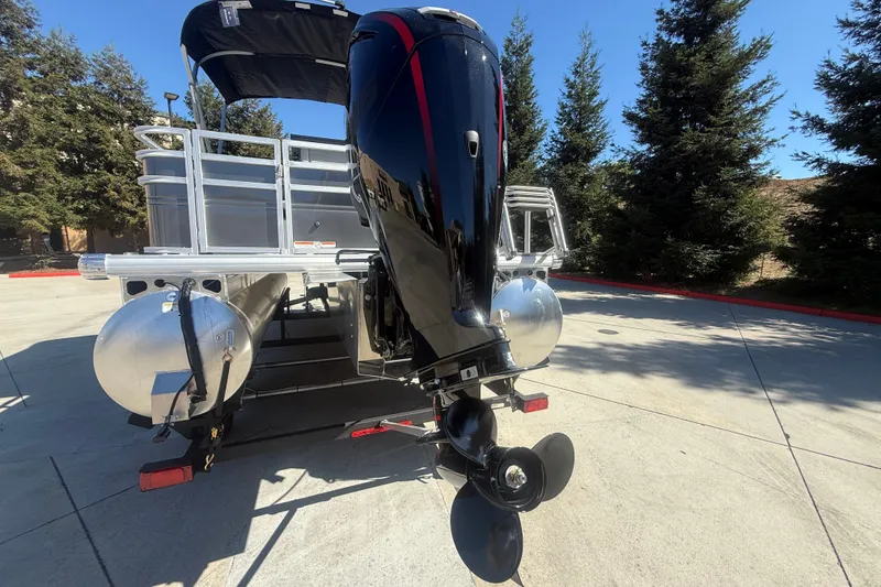 Slide: The Image of 2027 Sun Tracker SportFish 20 DLX pontoon boat with powerful outboard motor. - 13