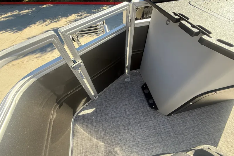 Slide: The Image of 2027 Sun Tracker SportFish 20 DLX boat interior with open gate and textured flooring. - 25