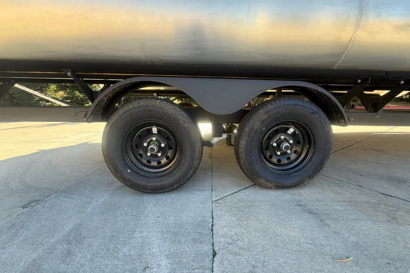 Slide: The Image of Trailer wheels of 2027 Sun Tracker SportFish 20 DLX on concrete surface. - 54