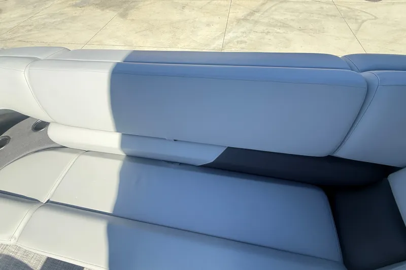 Slide: The Image of 2027 Sun Tracker SportFish 20 DLX boat seat with cup holders, outdoor setting. - 51