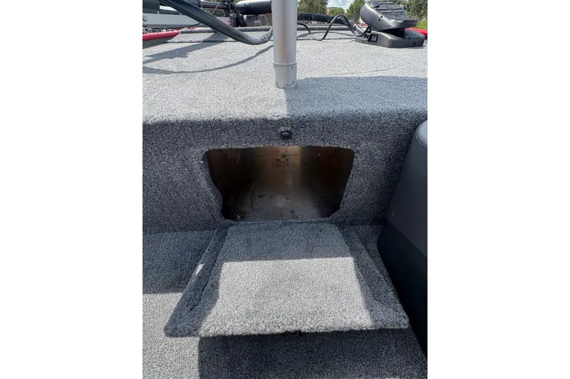 Slide: The Image of Interior view of 2027 Tracker Bass Tracker Classic XL boat with carpeted storage compartment. - 13