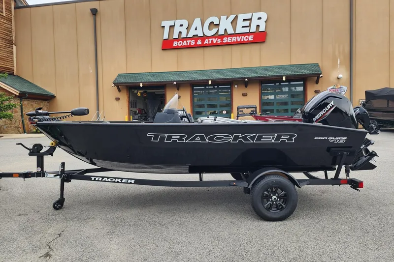 The Image of 2027 Tracker Pro Guide V-16 SC boat on trailer outside dealership. - 0