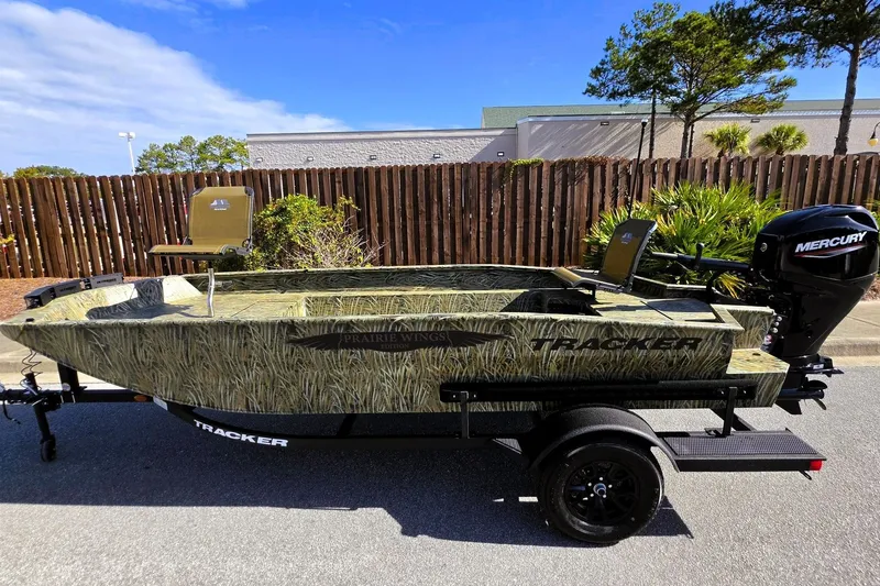 Slide: The Image of 2027 Tracker Grizzly 1650 T Prairie Wings Edition boat with camouflage design and Mercury engine. - 13