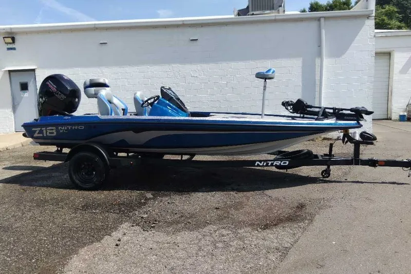 Slide: The Image of 2027 Nitro Z18 XL Pro fishing boat on trailer, parked outdoors. - 1