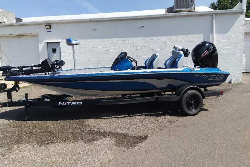 The Image of 2027 Nitro Z18 XL Pro boat in blue, parked on a trailer outdoors. - 0