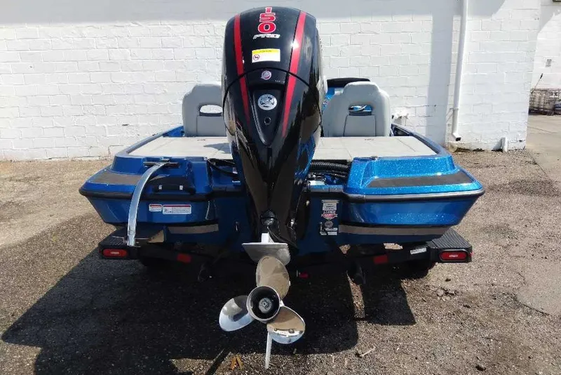 Slide: The Image of 2027 Nitro Z18 XL Pro boat with powerful outboard motor, parked on pavement. - 6