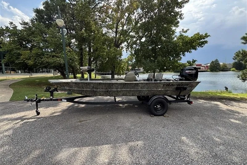 The Image of 2027 Tracker Grizzly 1754 SC boat on trailer by a scenic lake. - 0