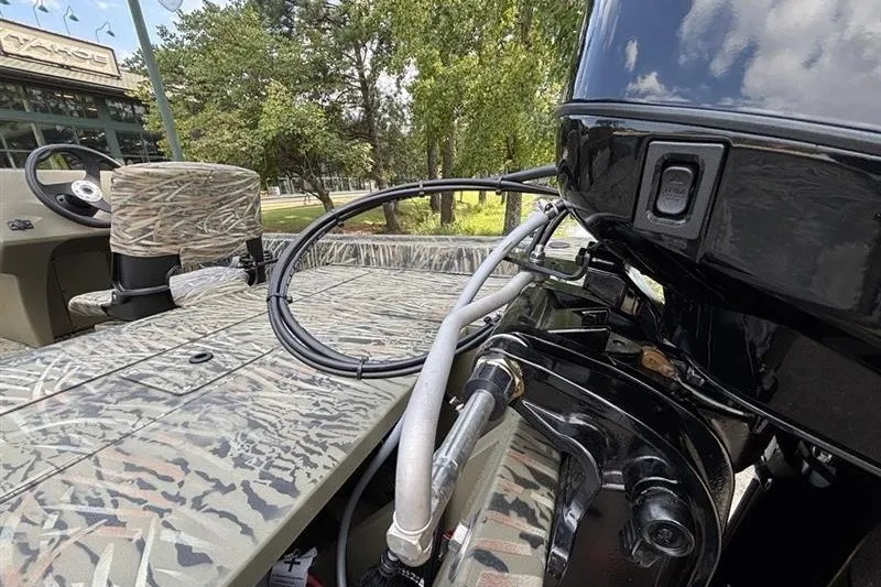 Slide: The Image of 2027 Tracker Grizzly 1754 SC boat with camouflage seating and powerful outboard motor. - 14