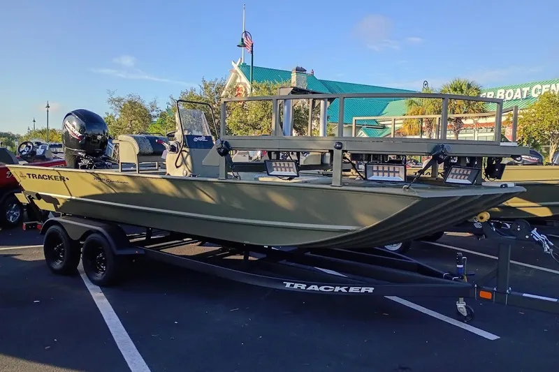 The Image of 2027 Tracker Grizzly 2072 CC Sportsman boat on trailer in parking lot. - 0