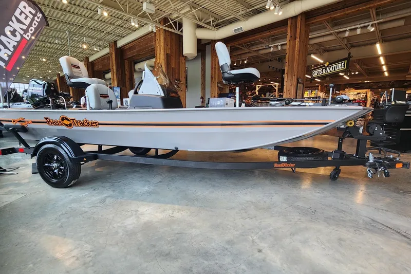 The Image of 2027 Tracker Bass Tracker Classic Limited boat displayed indoors on a trailer. - 0