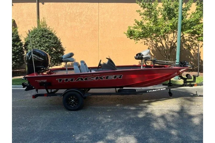 The Image of 2027 Tracker Pro Team 175 boat in red, parked on a trailer outdoors. - 0