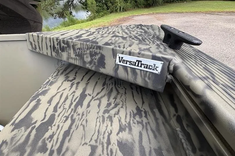 Slide: The Image of 2027 Tracker Grizzly 1648 SC boat with camo pattern and VersaTrack system. - 14