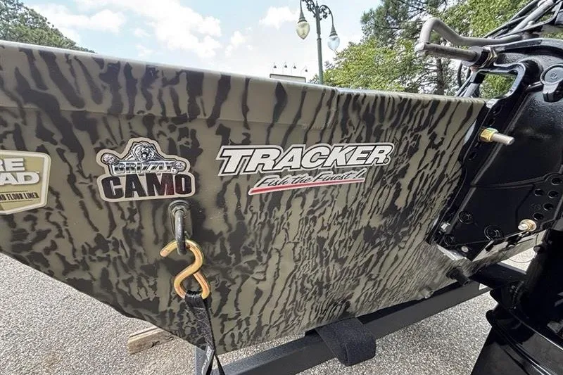 Slide: The Image of 2027 Tracker Grizzly 1648 SC boat with camo design and logo decals. - 15