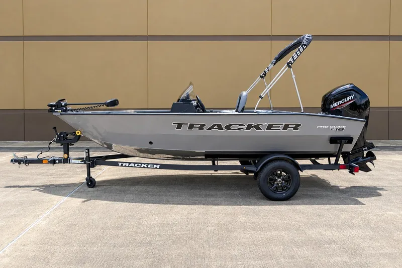 The Image of 2027 Tracker Pro Guide V-16 SC boat on trailer, featuring Mercury outboard motor. - 0