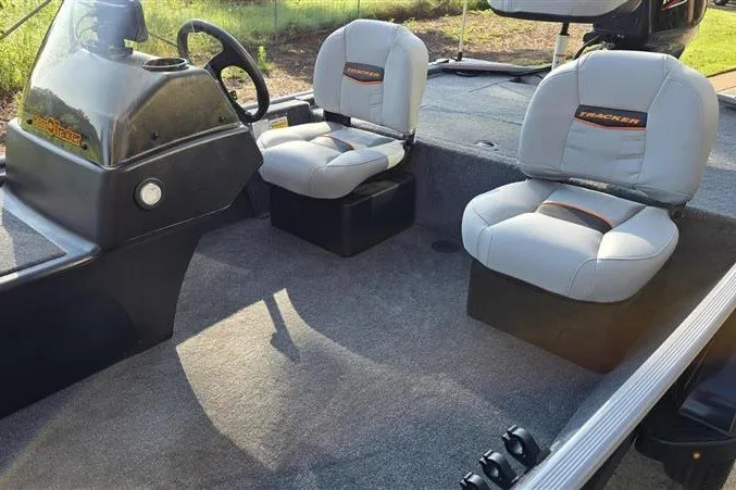 Slide: The Image of 2027 Tracker Bass Tracker Classic Limited boat interior with two cushioned seats and steering console. - 16