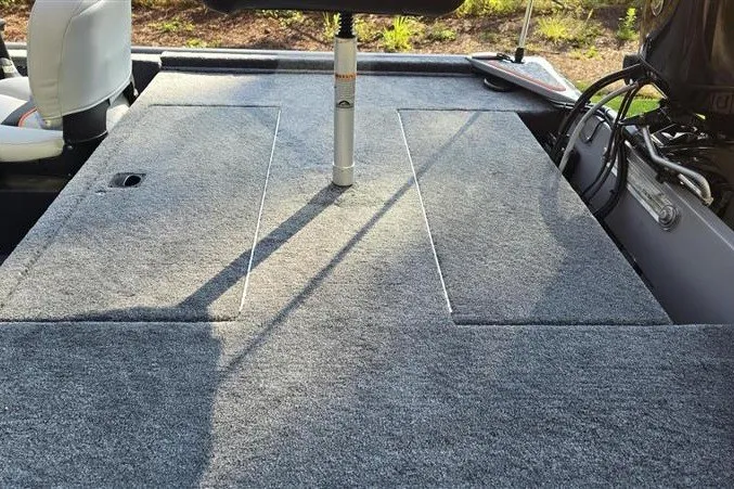 Slide: The Image of 2027 Tracker Bass Tracker Classic Limited boat deck with carpeted surface and seating. - 15