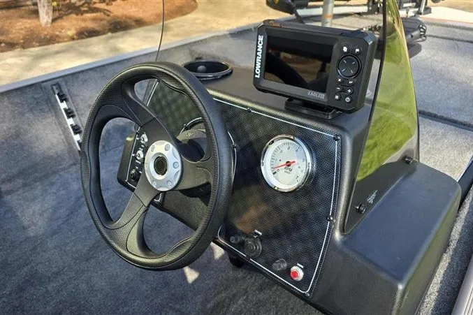 Slide: The Image of 2027 Tracker Bass Tracker Classic Limited dashboard with steering wheel and Lowrance fish finder. - 14