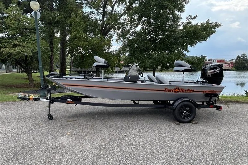 Slide: The Image of 2027 Tracker Bass Tracker Classic Limited boat parked near a scenic lake. - 14