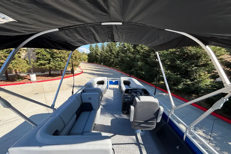 Slide: The Image of 2027 Sun Tracker SportFish 22 DLX pontoon boat interior with seating and steering console. - 14