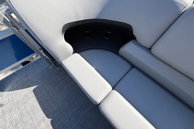 Slide: The Image of 2027 Sun Tracker SportFish 22 DLX boat seating with cup holders and gray upholstery. - 34