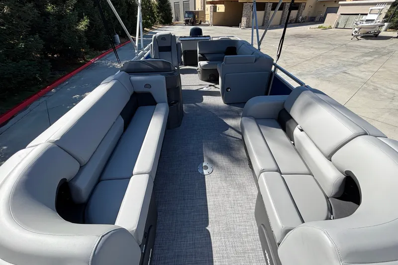 Slide: The Image of 2027 Sun Tracker SportFish 22 DLX pontoon boat with spacious seating and modern design. - 13