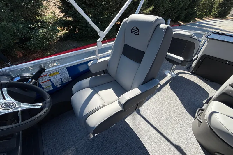 Slide: The Image of 2027 Sun Tracker SportFish 22 DLX boat interior with gray captain's chair and steering wheel. - 23