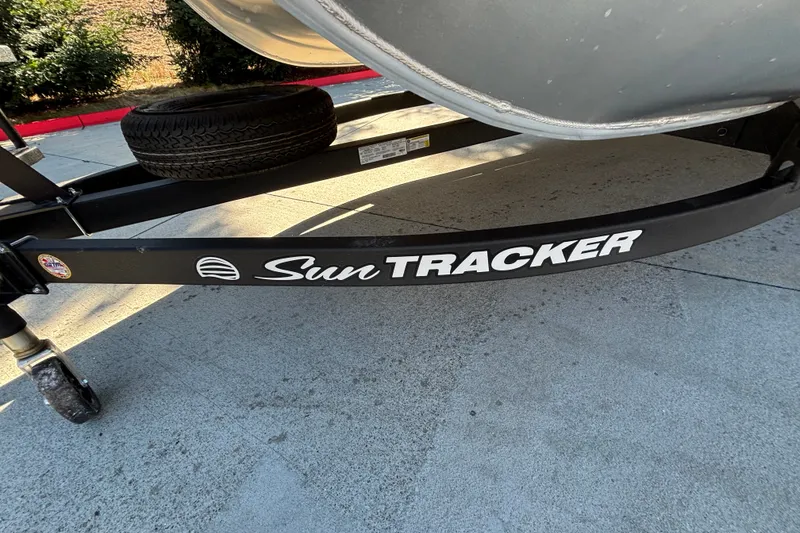Slide: The Image of Trailer of 2027 Sun Tracker SportFish 22 DLX boat on pavement. - 62