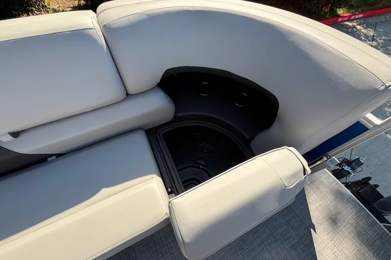 Slide: The Image of 2027 Sun Tracker SportFish 22 DLX boat seating with storage compartment, gray upholstery. - 57