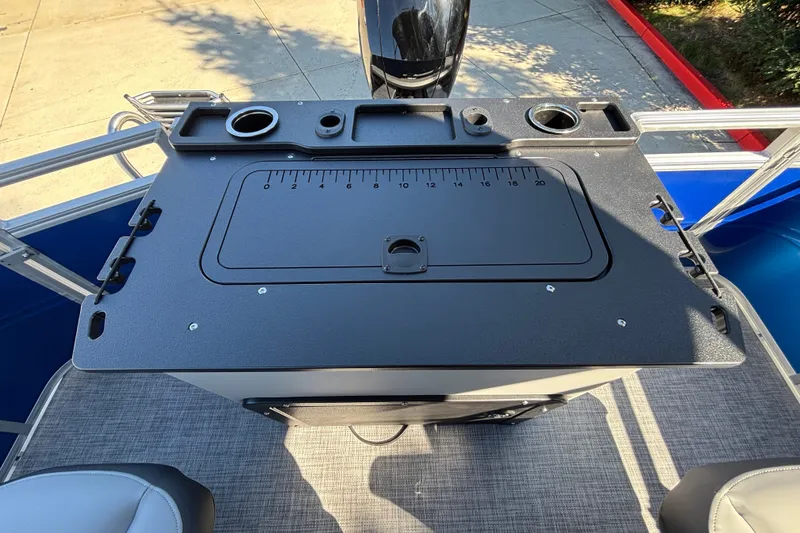 Slide: The Image of Sun Tracker SportFish 22 DLX 2027 boat console with cup holders and measurement markings. - 37