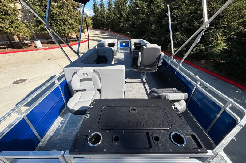 Slide: The Image of 2027 Sun Tracker SportFish 22 DLX pontoon boat interior with seating and fishing amenities. - 15