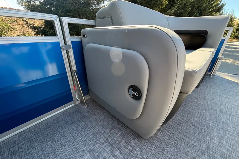 Slide: The Image of 2027 Sun Tracker SportFish 22 DLX pontoon boat interior with gray seating and blue paneling. - 46