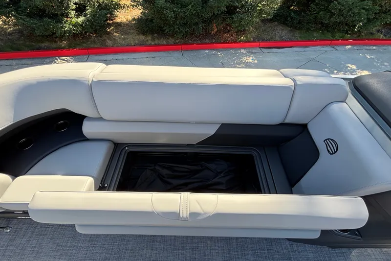 Slide: The Image of Sun Tracker SportFish 22 DLX 2027 boat interior with open storage compartment and cushioned seating. - 28