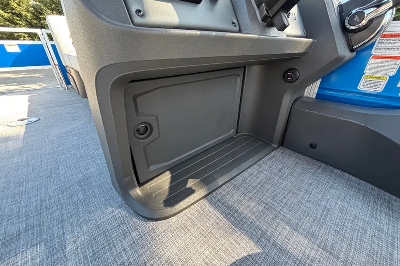 Slide: The Image of 2027 Sun Tracker SportFish 22 DLX boat interior, featuring a storage compartment and steering console. - 21