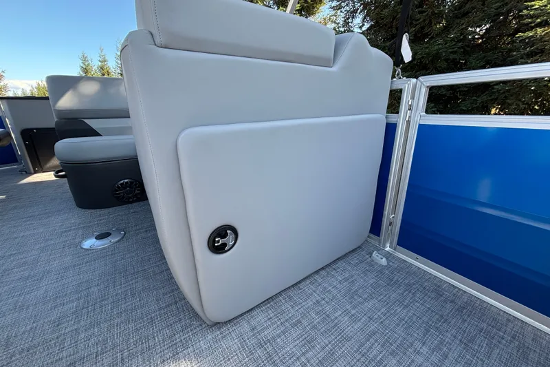 Slide: The Image of 2027 Sun Tracker SportFish 22 DLX interior with gray seating and blue paneling. - 49