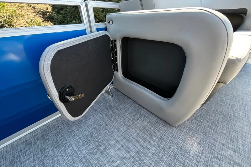 Slide: The Image of Open storage compartment on 2027 Sun Tracker SportFish 22 DLX boat with gray interior. - 45