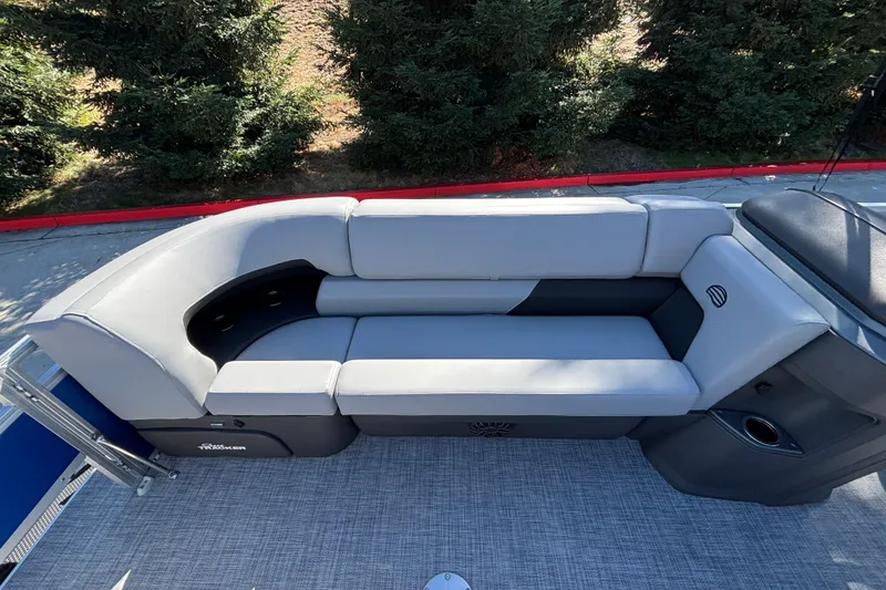 Slide: The Image of 2027 Sun Tracker SportFish 22 DLX boat interior with gray seating and cup holders. - 33