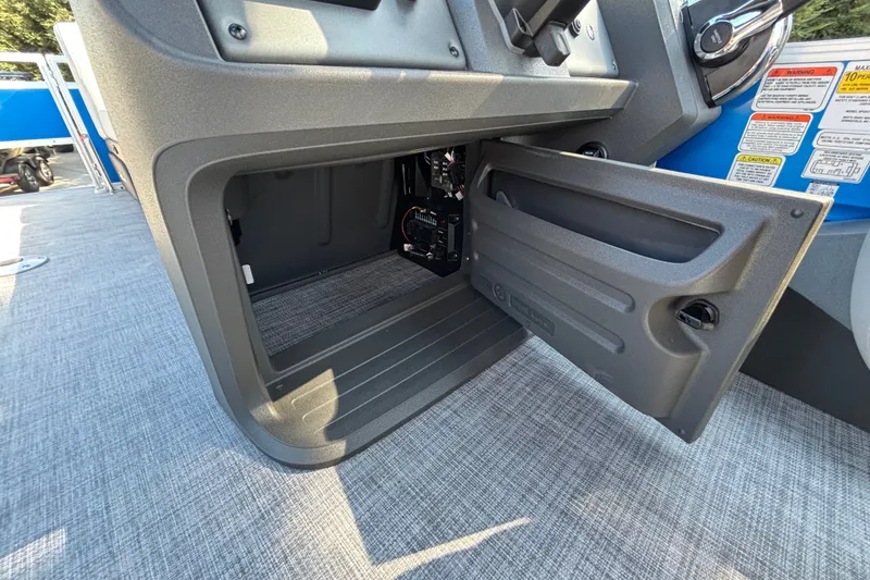 Slide: The Image of Open storage compartment on 2027 Sun Tracker SportFish 22 DLX boat, showcasing interior space. - 20