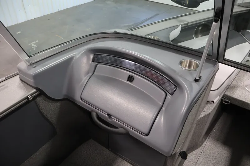 Slide: The Image of 2013 Lund 1750 Tyee boat interior with glove compartment and cup holder. - 28