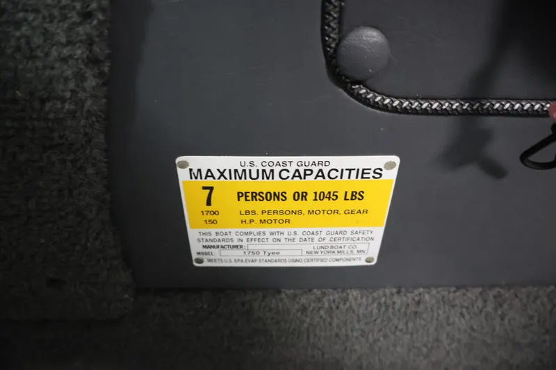 Slide: The Image of Capacity label on 2013 Lund 1750 Tyee boat, showing limits for persons and weight. - 26
