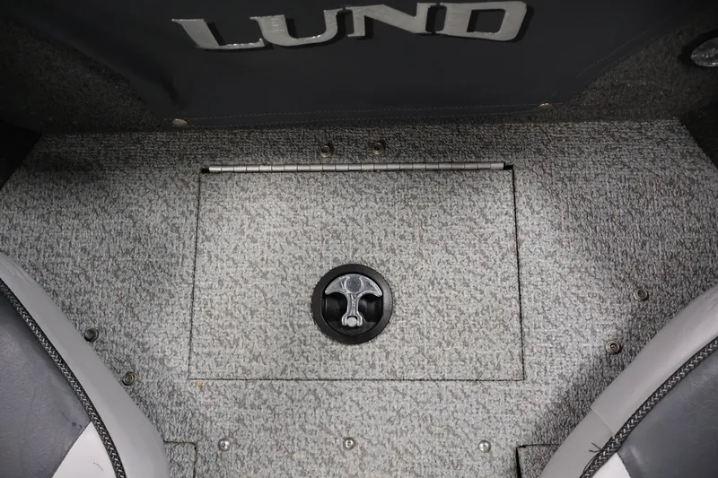 Slide: The Image of 2013 Lund 1750 Tyee boat floor with storage compartment and latch. - 15