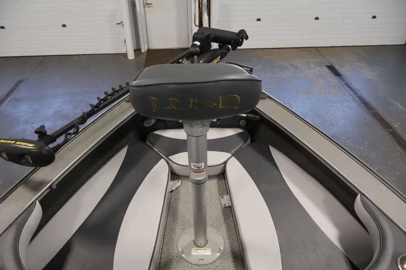 Slide: The Image of 2013 Lund 1750 Tyee boat interior with seating and trolling motor. - 21