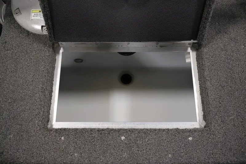 Slide: The Image of Open storage compartment in 2013 Lund 1750 Tyee boat, featuring carpeted interior. - 37