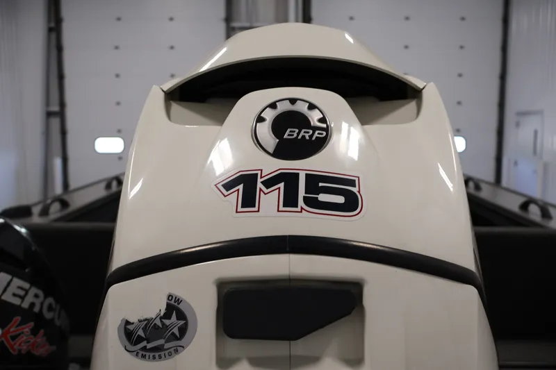 Slide: The Image of 2013 Lund 1750 Tyee boat with BRP 115 engine in a garage setting. - 45