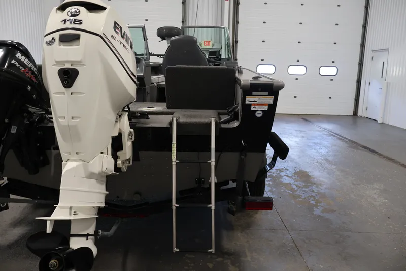 Slide: The Image of 2013 Lund 1750 Tyee boat with Evinrude 115 engine in a garage. - 60