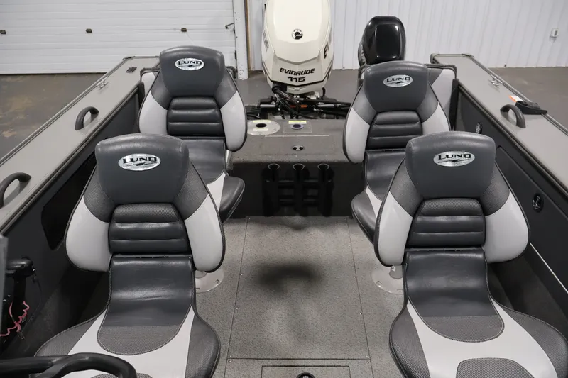 Slide: The Image of 2013 Lund 1750 Tyee boat interior with four seats and Evinrude motor. - 33