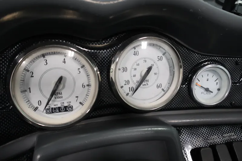 Slide: The Image of Dashboard gauges of a 2013 Lund 1750 Tyee boat, showing RPM, speed, and fuel levels. - 22