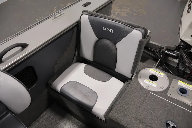 Slide: The Image of 2013 Lund 1750 Tyee boat seat with gray upholstery and storage compartments. - 38