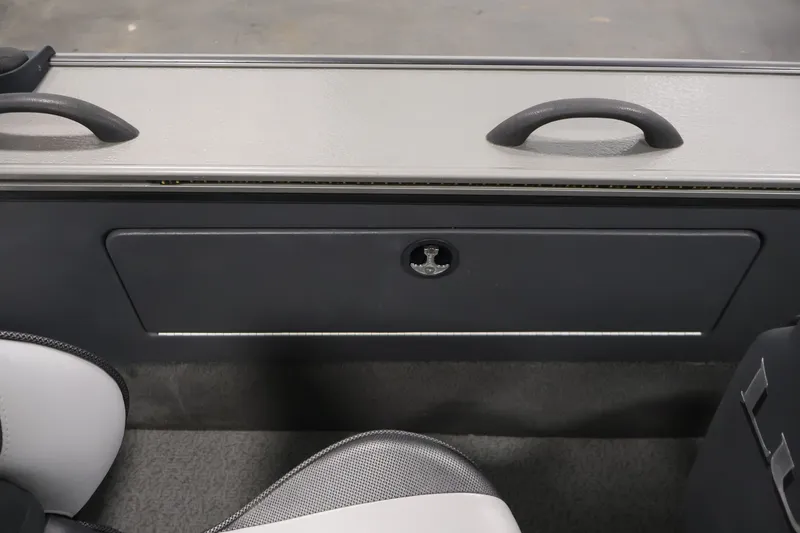 Slide: The Image of Interior view of a 2013 Lund 1750 Tyee boat, featuring seating and storage compartment. - 34